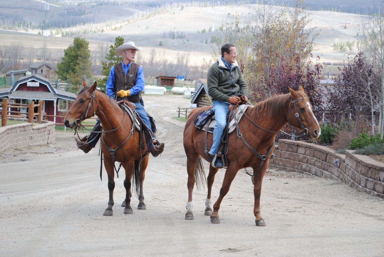 Richard Quest with rancher Connie Dorsey on horseback in Grandby, Colorado.