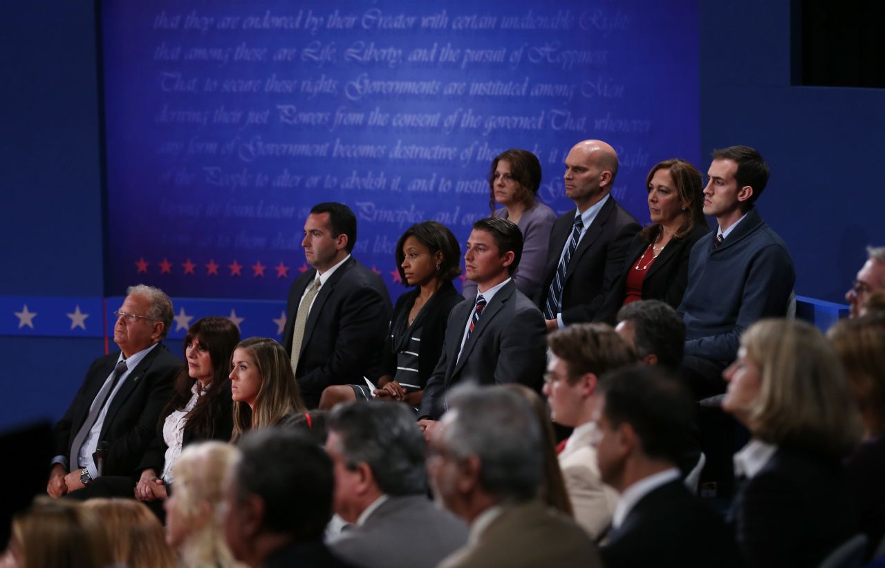Members of the audience have taken their seats.