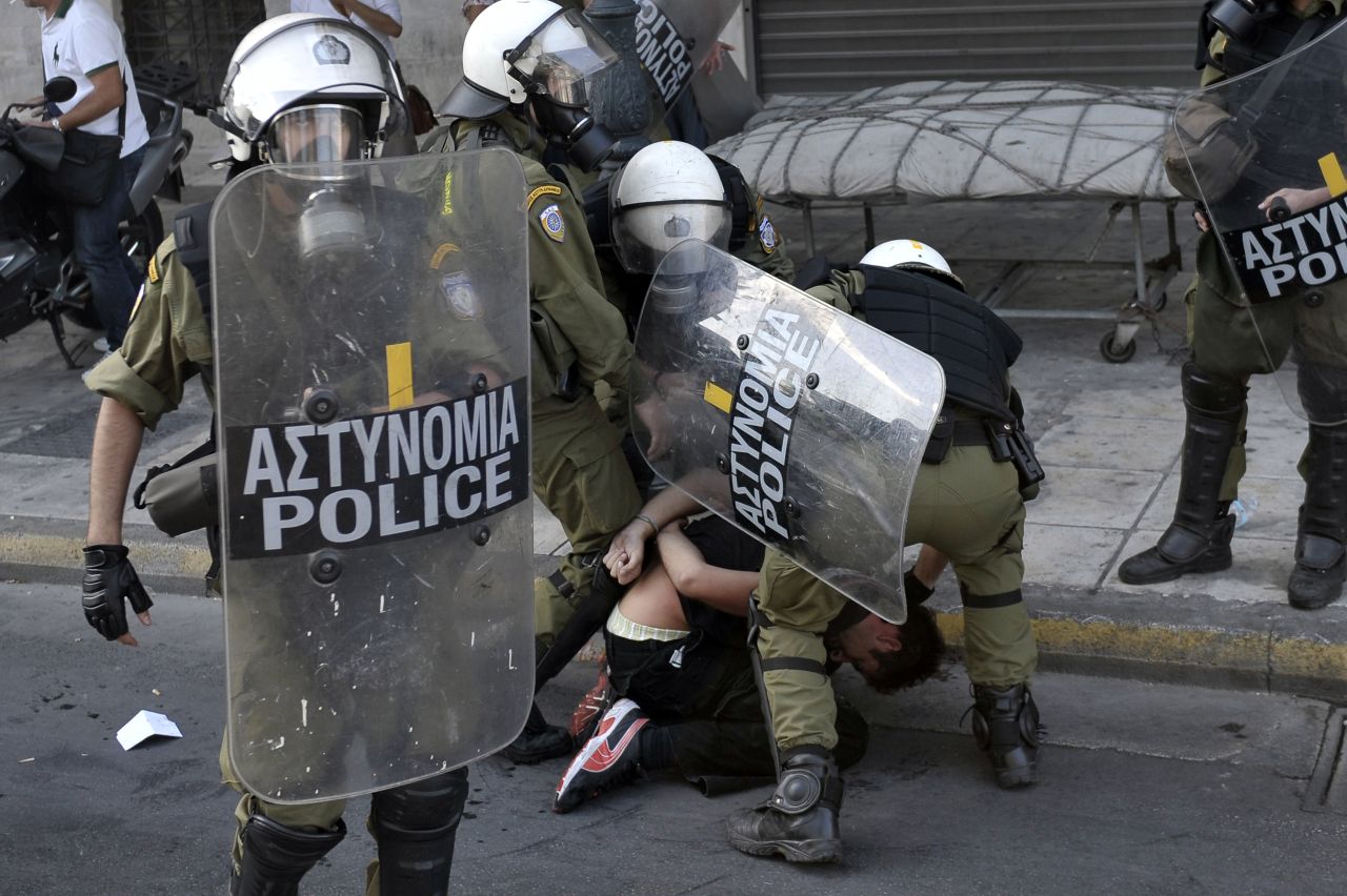 Police detain an anti-austerity demonstrator in Athens.