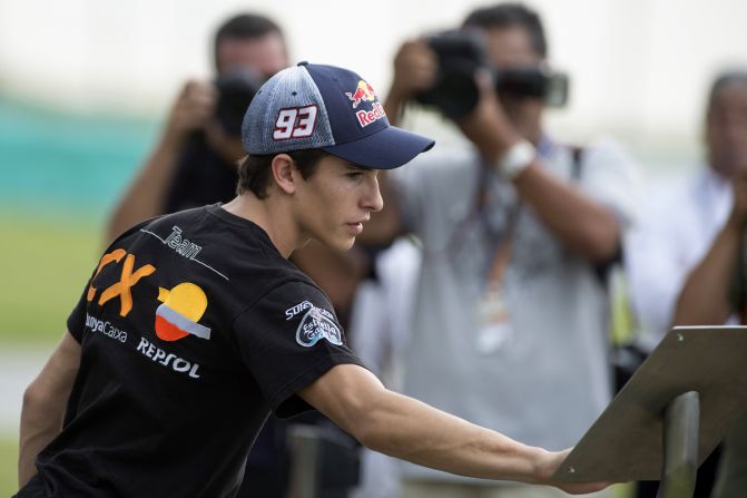Marc Marquez of Spain and Team Catalunya Caixa Repsol touches the plaque during the ceremony. The Spaniard, who is hoping to claim the Moto2 title this weekend, looked emotional throughout the ceremony.
