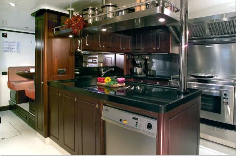 The galley on board 53m superyacht Red Dragon. Each kitchen is specially designed for the high seas with barriers around the hob and latches on cupboards to prevent food from spilling in rough weather.