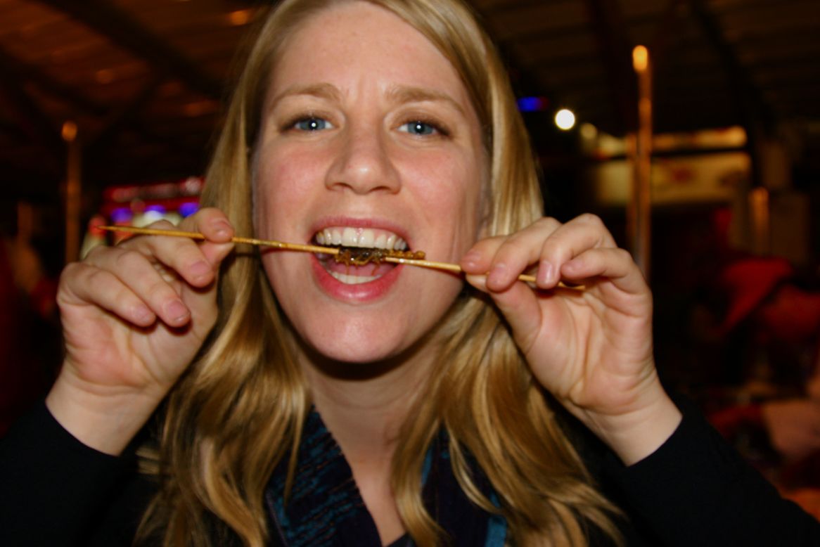 Elyse Pasquale bites down on a scorpion skewer in Beijing, China. The American journalist and food blogger is on a culinary adventure to sample 100 different dishes in 100 countries.