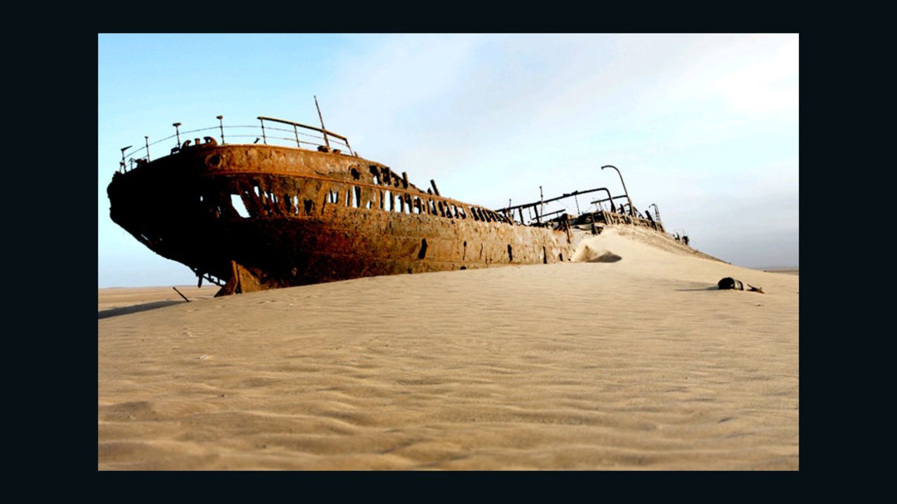 Ships' skeletons rest on the shore, beside whale bones.
