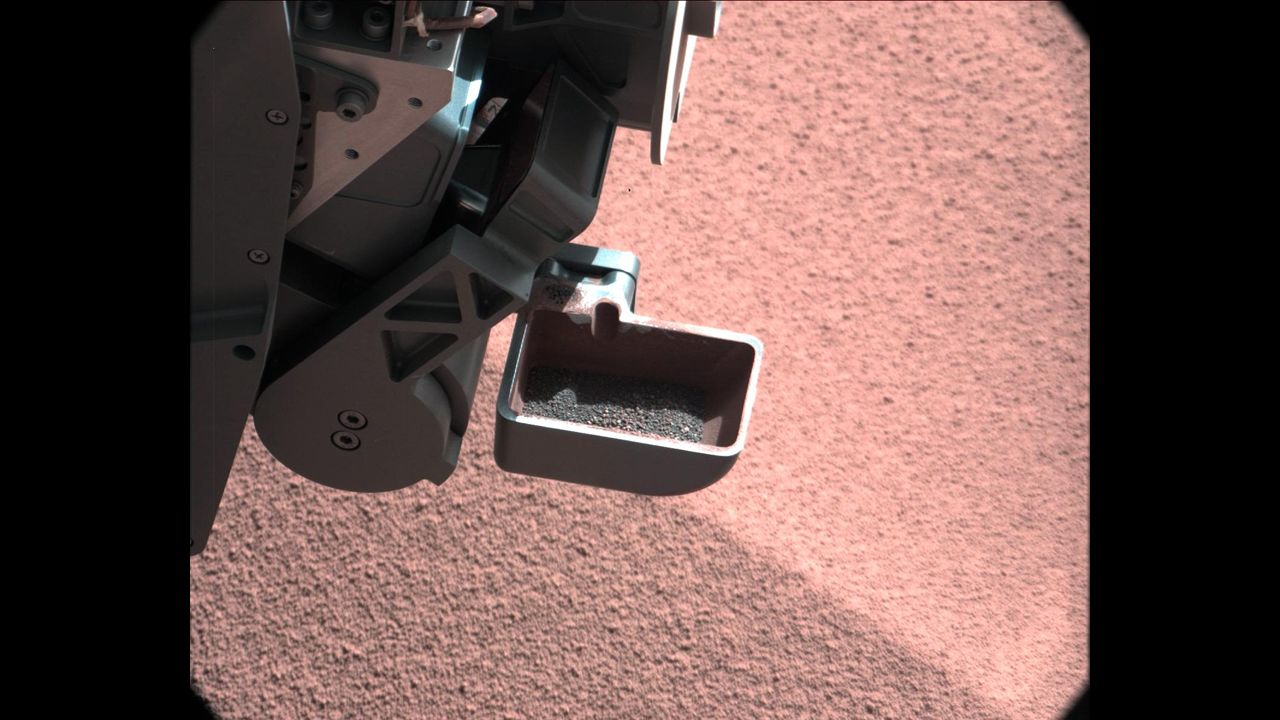 The rover's scoop contains larger soil particles that were too big to filter through a sample-processing sieve. After a full-scoop sample had been vibrated over the sieve, this portion was returned to the scoop for inspection by the rover's mast camera.