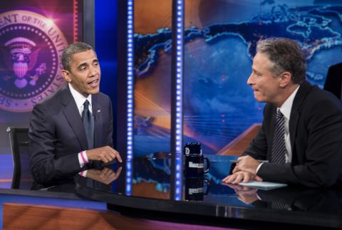 Barack Obama and Jon Stewart speak during a break in the live taping of Comedy Central's "The Daily Show with Jon Stewart" on Thursday.