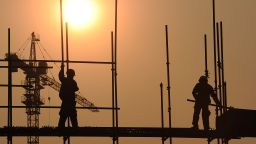   This picture taken on September 26, 2012 shows workers on a scaffold at a construction site in Hefei, central China's Anhui province. China has approved a massive infrastructure package worth more than 158 billion USD, state media said on September 7, as the government seeks to boost the flagging economy. 