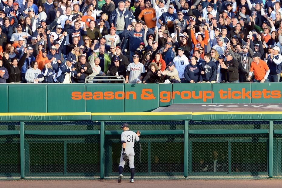 Ichiro Suzuki of the New York Yankees stands at the wall as fans cheer a two-run homerun by Jhonny Peralta of the Detroit Tigers on Thursday.