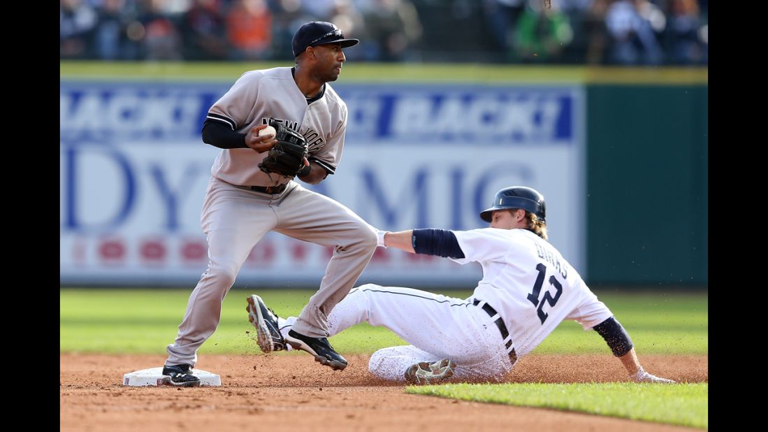 Andy Dirks of the Detroit Tigers is forced out at second base by Eduardo Nunez of the New York Yankees.