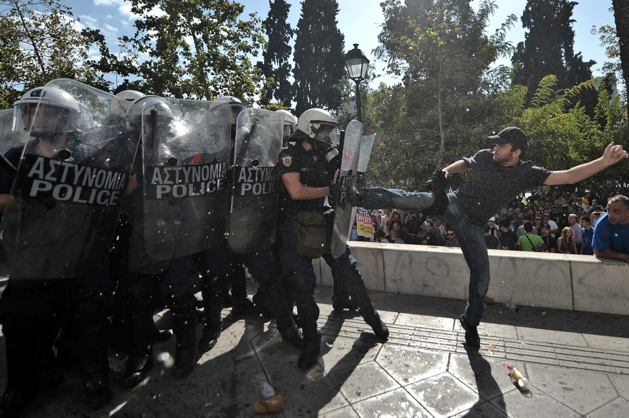A demonstrator clashes with riot police in Athens.