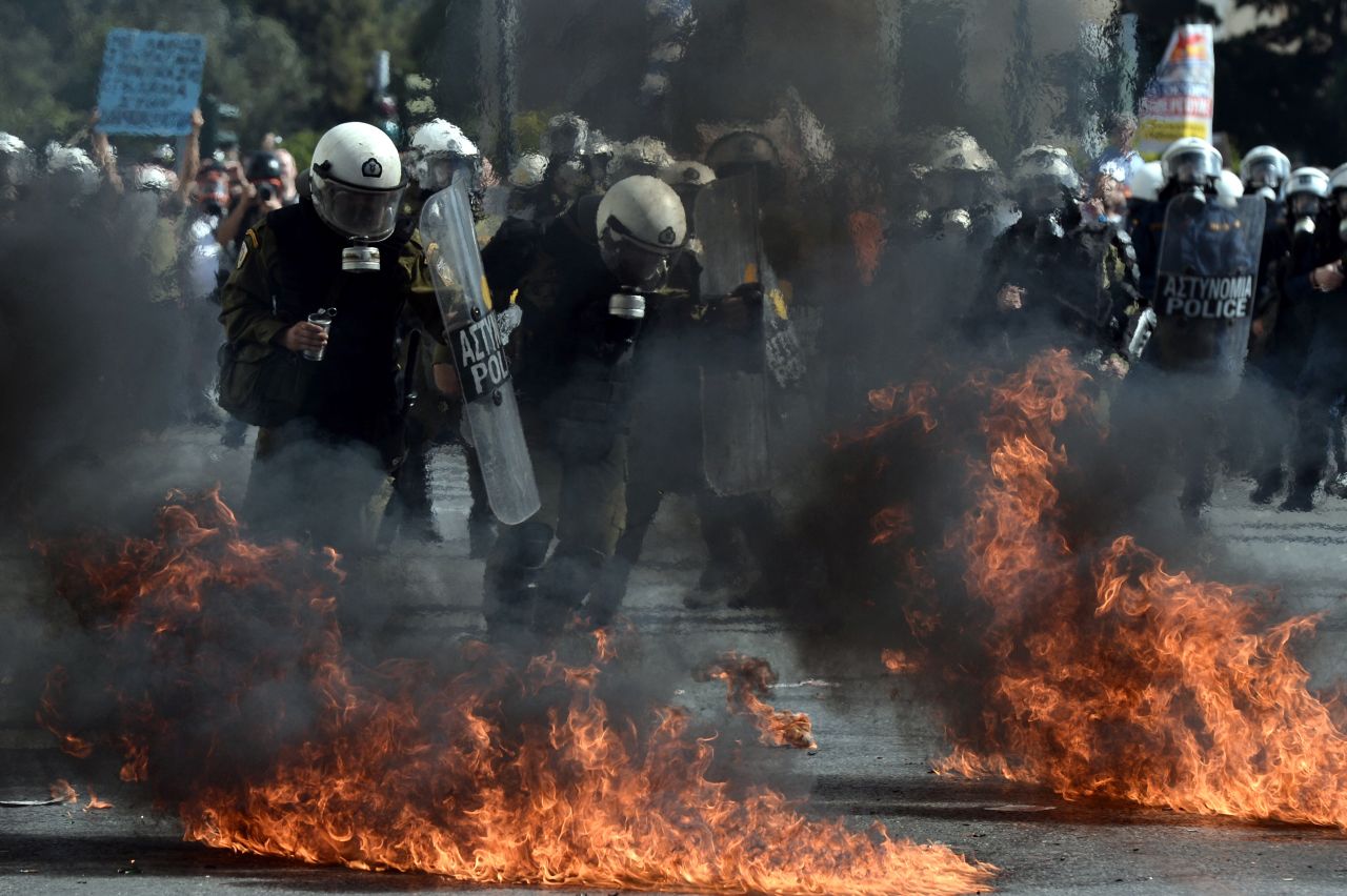 Riot police clash with demonstrators at an anti-austerity rally in Athens on October 18, 2012. The rally took place as workers across the country went on a 24-hour strike and EU leaders met to discuss the eurozone crisis.