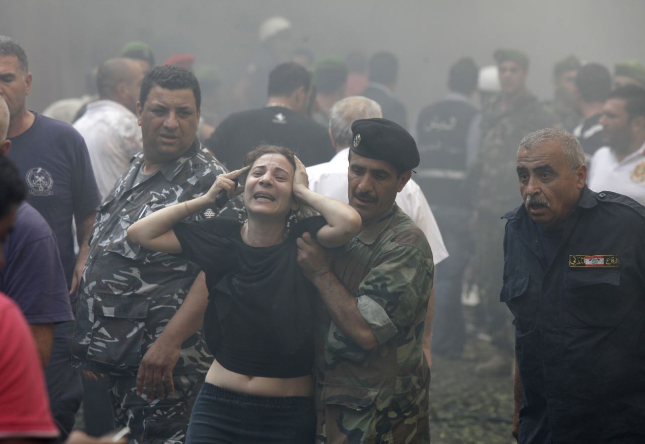 A woman is helped by a Lebanese soldier after the explosion.