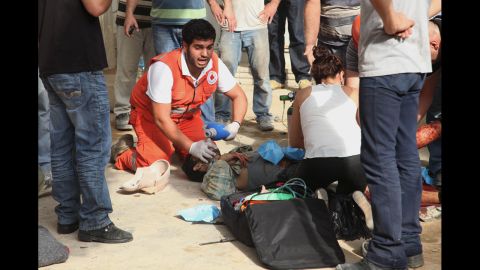 Lebanese Red Cross aid workers help a wounded man. Dozens were injured, some seriously, and others were slightly hurt, a senior hospital official said.