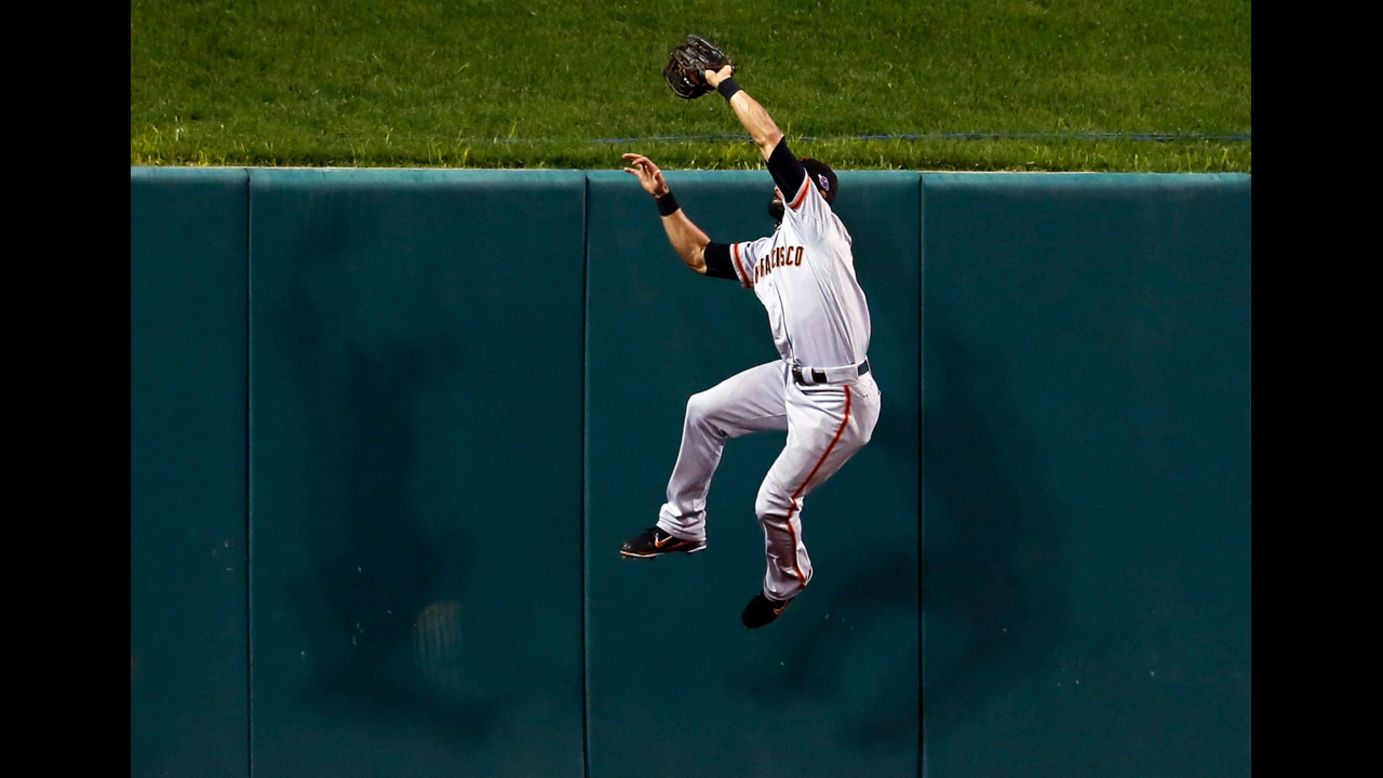 Angel Pagan of the San Francisco Giants makes a catch at the wall on a ball hit by Yadier Molina of the St. Louis Cardinals.