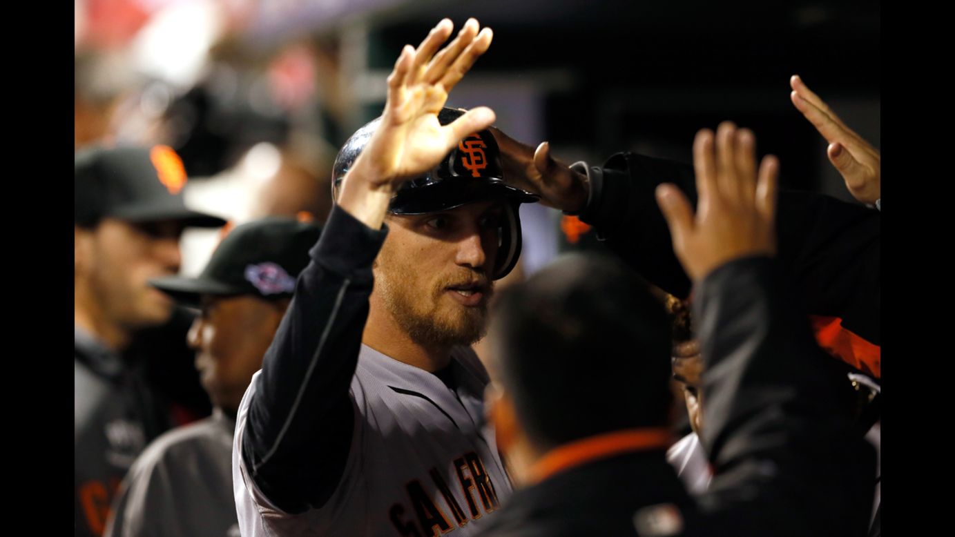 Hunter Pence of the San Francisco Giants is congratulated in the dugout after hitting a solo home run in the second inning.