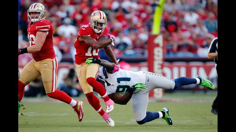 Wide receiver Kyle Williams of the San Francisco 49ers breaks away from defensive end Chris Clemons of the Seattle Seahawks.