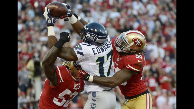 Braylon Edwards of the Seattle Seahawks has this pass broken up in the end zone by Patrick Willis and Dashon Goldson of the San Francisco 49ers.