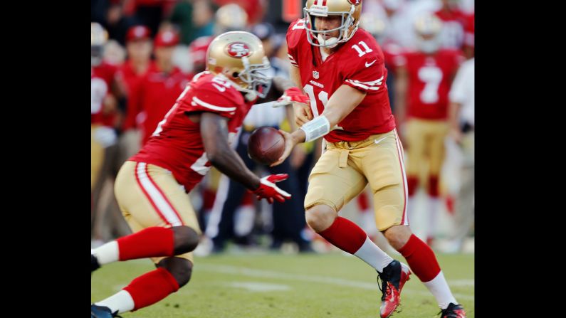 Quarterback Alex Smith hands off to running back Frank Gore during Thursday's game against the Seattle Seahawks.