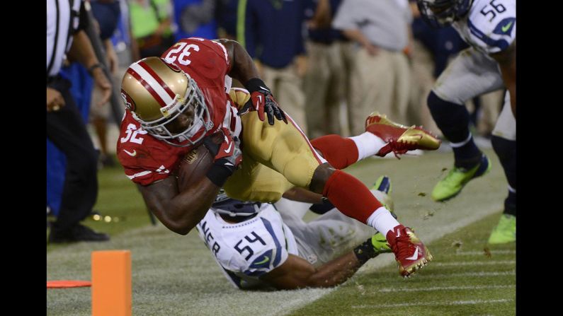 San Francisco's Kendall Hunter is forced out of bounds by Seahawks player Bobby Wagner before the play was called back because of a penalty on the offensive line during the fourth quarter of an NFL football game at Candlestick Park on Thursday, October 18, in San Francisco. The 49ers won the game 13-6.