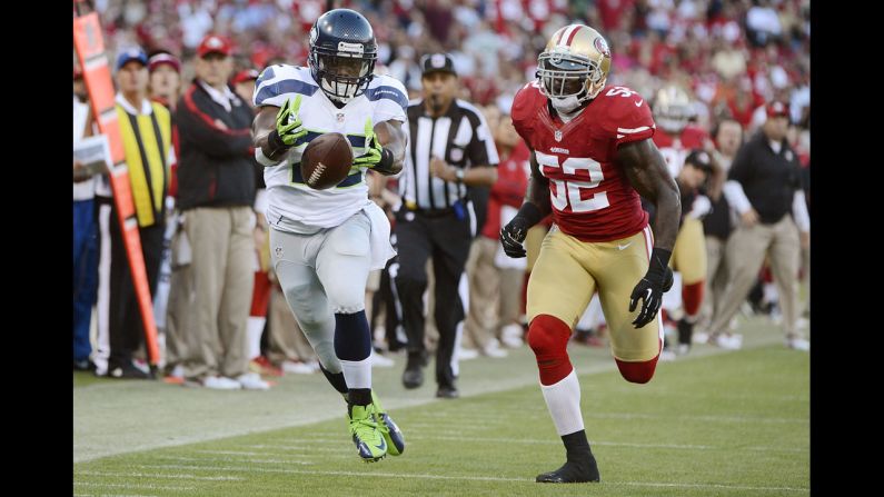 Runningback Robert Turbin, left, of the Seattle Seahawks beats Patrick Willis of the San Francisco 49ers.