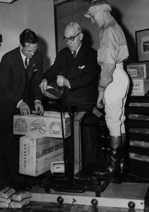 Australian jockey Scobie Breasley's weight is measured in sultanas in 1959. Riders must follow strict low-calorie diets to keep their weight down. 