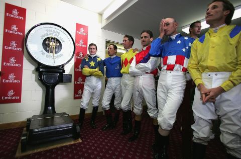 Jockeys line up for weighing ahead of the Melbourne Cup.