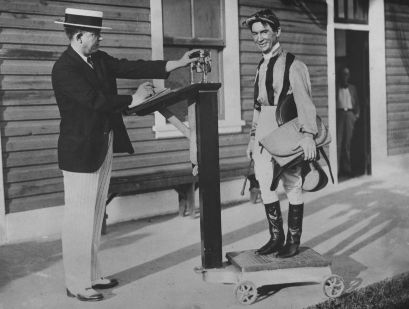 British jockey Steve Donoghue is weighed before a race in 1930.