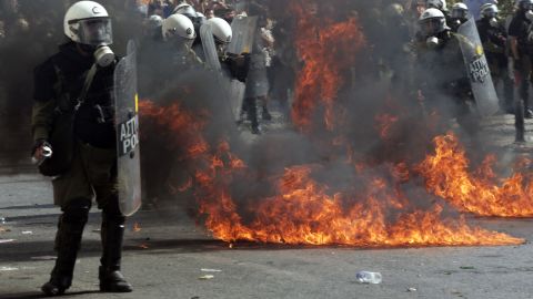 Protesters throw petrol bombs at riot police officers during strike on October 18, 2012 in Athens, Greece.