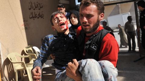 A wounded boy is carried to a hospital after an airstrike by government forces in Maaret al-Numan in Syria on Thursday.