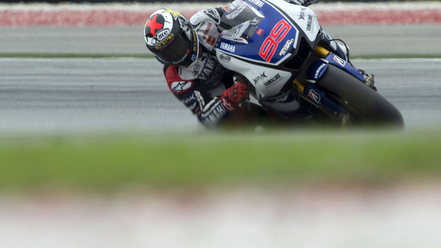 Spain's Jorge Lorenzo beat Valentino Rossi's lap record at the Sepang International Circuit in qualifying.