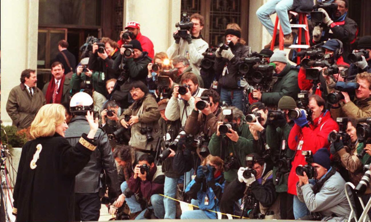 Clinton waves to the media in January 1996 as she arrives for an appearance before a grand jury in Washington. The first lady was subpoenaed to testify as a witness in the investigation of the Whitewater land deal in Arkansas. The Clintons' business investment was investigated, but ultimately they were cleared of any wrongdoing.