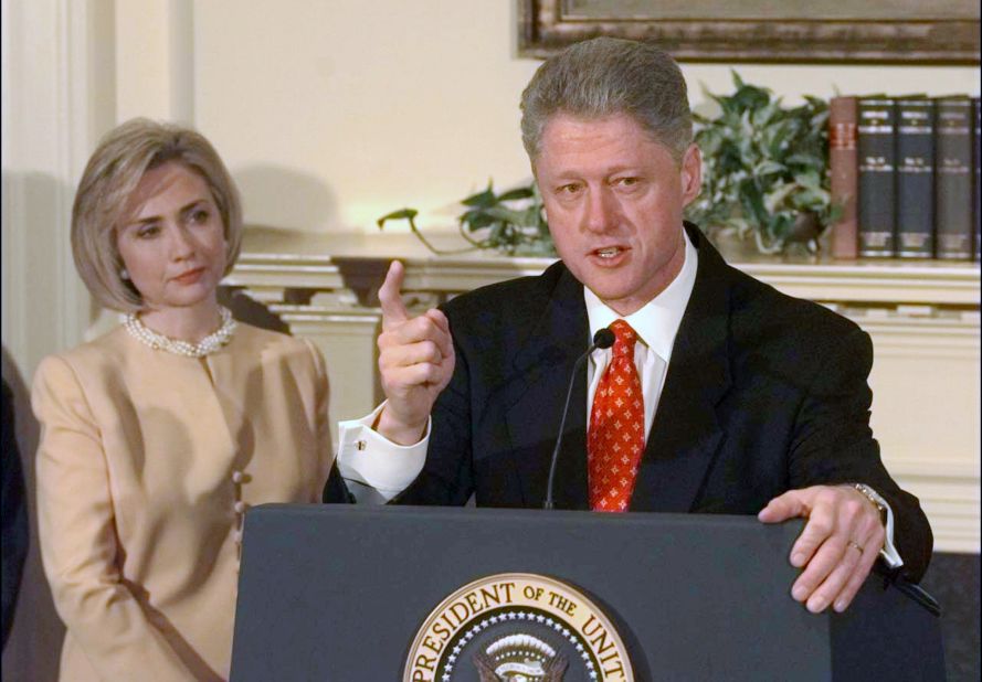 Clinton looks on as her husband discusses the Monica Lewinsky scandal in the Roosevelt Room of the White House on January 26, 1998. Clinton declared, "I did not have sexual relations with that woman." In August of that year, Clinton testified before a grand jury and admitted to having "inappropriate intimate contact" with Lewinsky, but he said it did not constitute sexual relations because they had not had intercourse. He was impeached in December on charges of perjury and obstruction of justice.