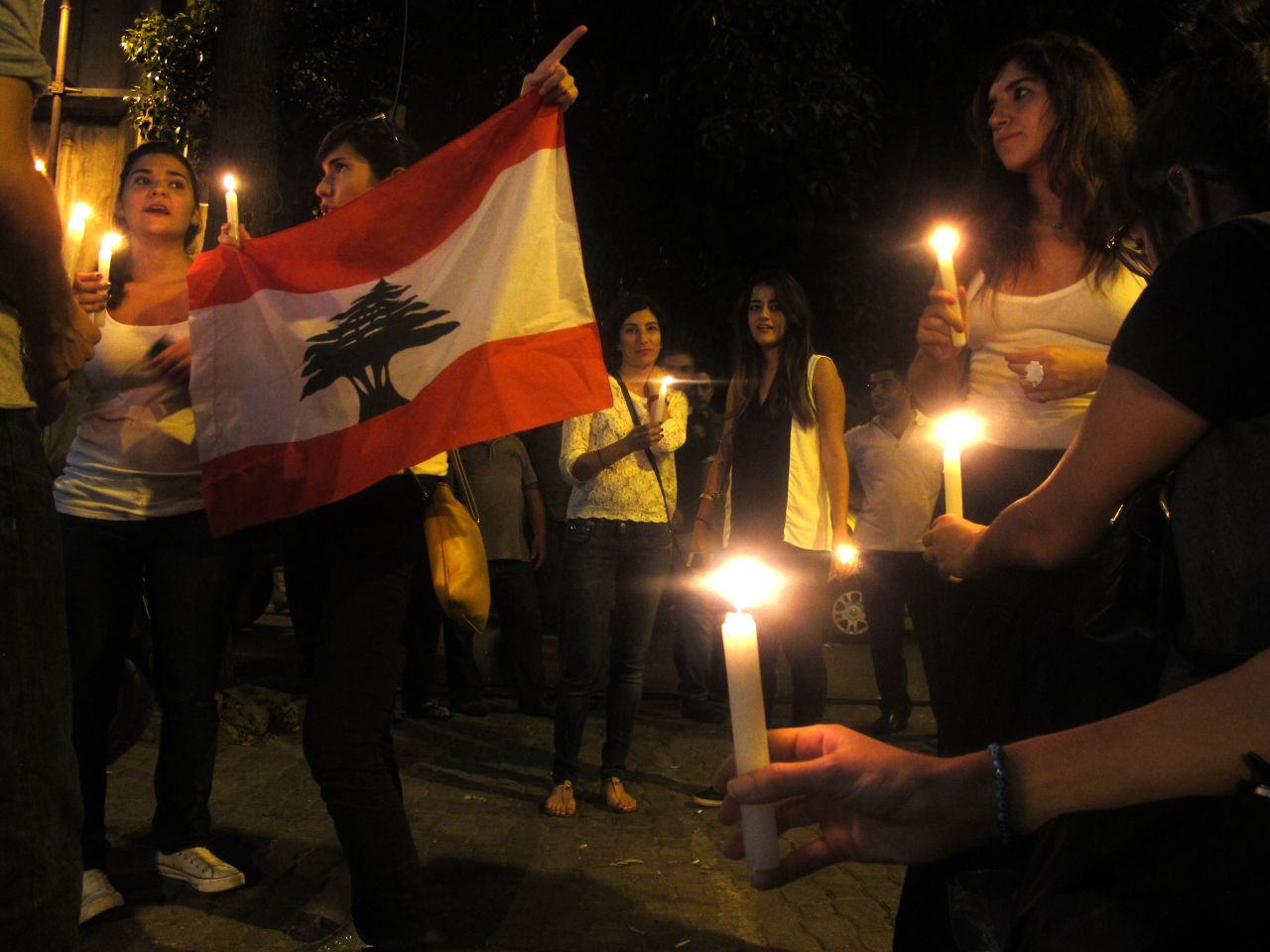 Lebanese people take part in a candlelight vigil near the site of the car bomb blast.