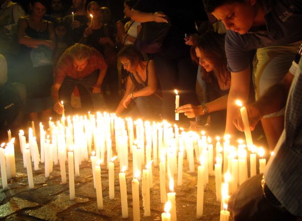 Lebanese light candles during a vigil near the site of the car bomb attack on Saturday.