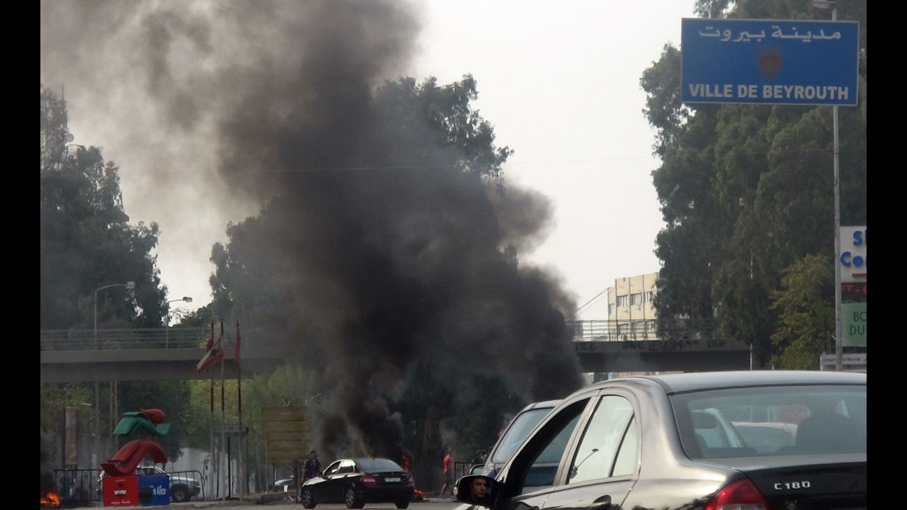 Smoke rises from burning tyres blocking the main northern entrance of Beirut on Saturday. Protesters blocked some roads in Beirut, Tripoli in the north, Sidon in the south, and the Bekaa Valley in the east.