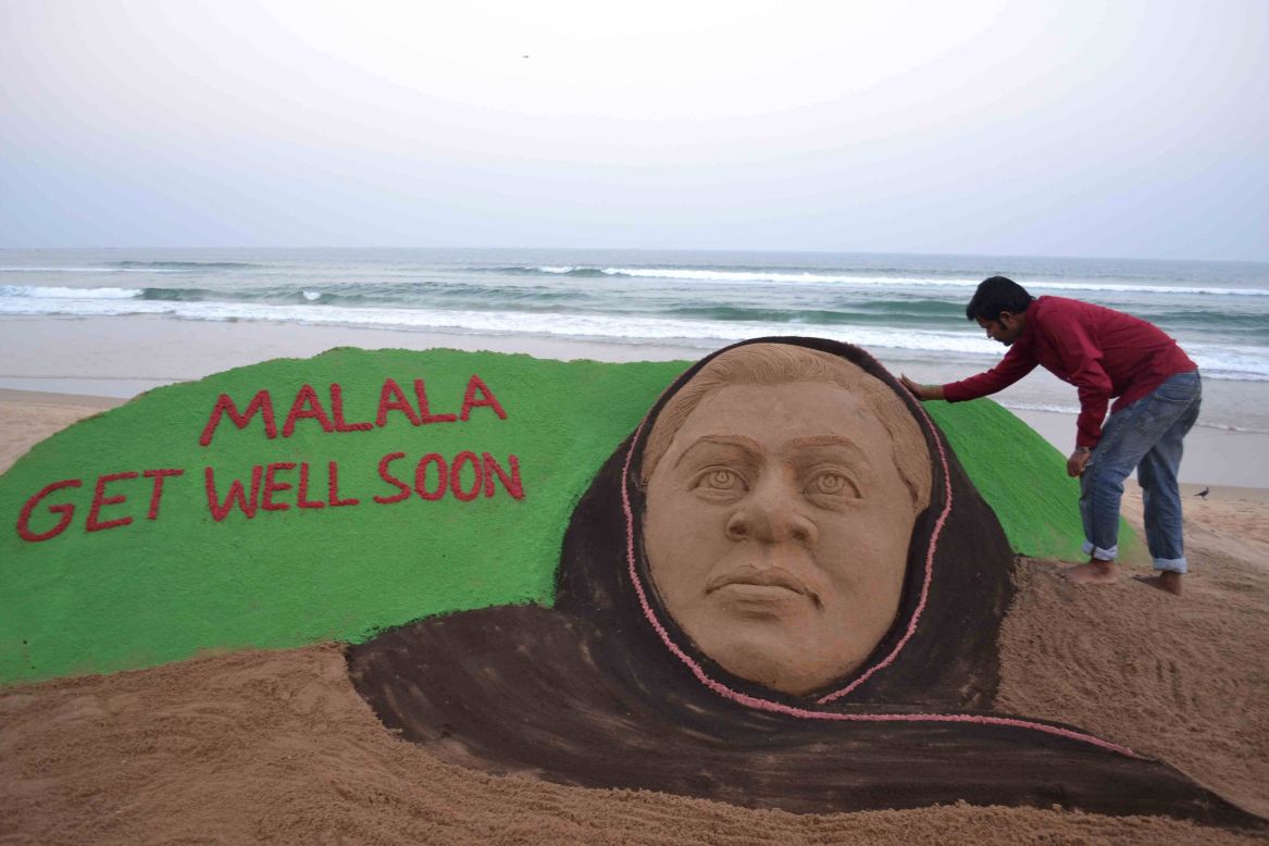 Indian sand artist Sudarsan Pattnaik puts final touches on a sand sculpture in honor of Malala at Puri Beach, India, on Tuesday, October 16.