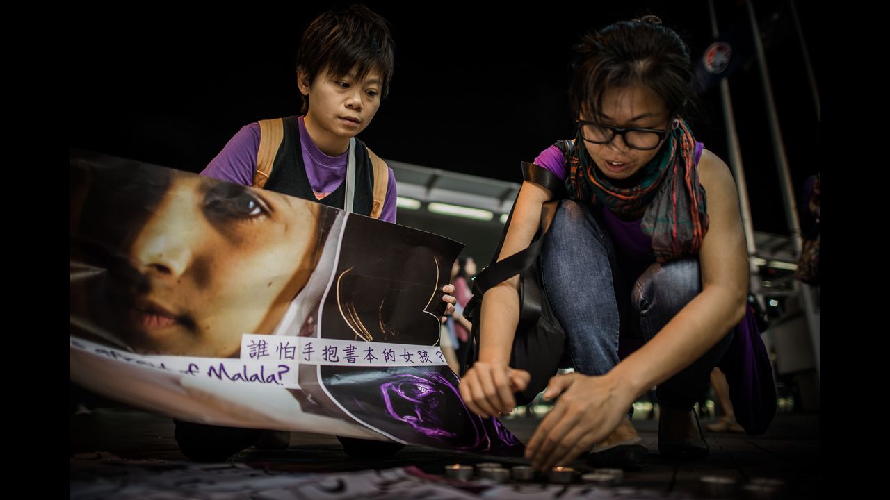 Activists light candles during Friday's vigil in Hong Kong.