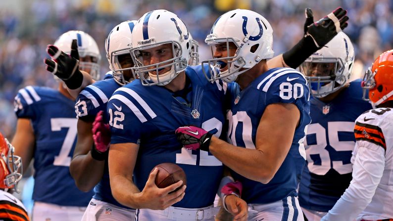 No. 12 quarterback Andrew Luck of the Indianapolis Colts is congratulated by No. 80 Coby Fleener and No. 83 Dwayne Allen after running for a touchdown against the Cleveland Browns.