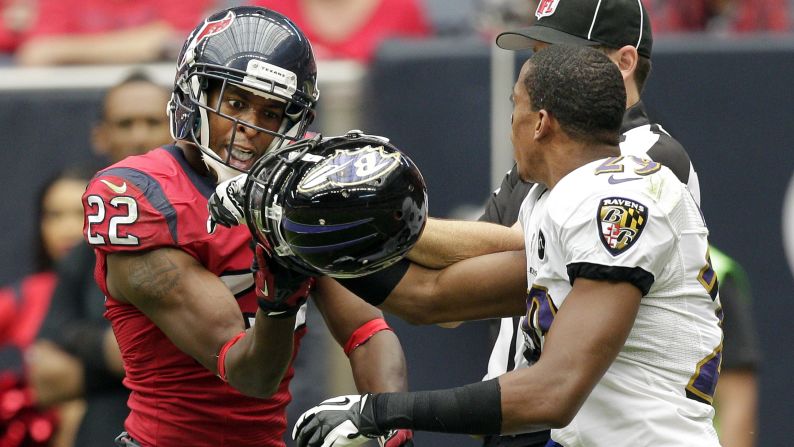 Alan Ball of the Houston Texans and Cary Williams of the Baltimore Ravens get tangled up in the second quarter on Sunday.
