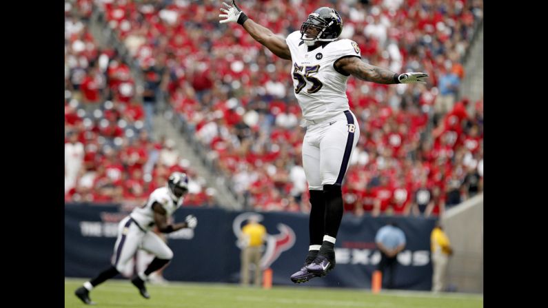 Terrell Suggs of the Ravens tries to knock down a pass by Texans quarterback Matt Schaub.