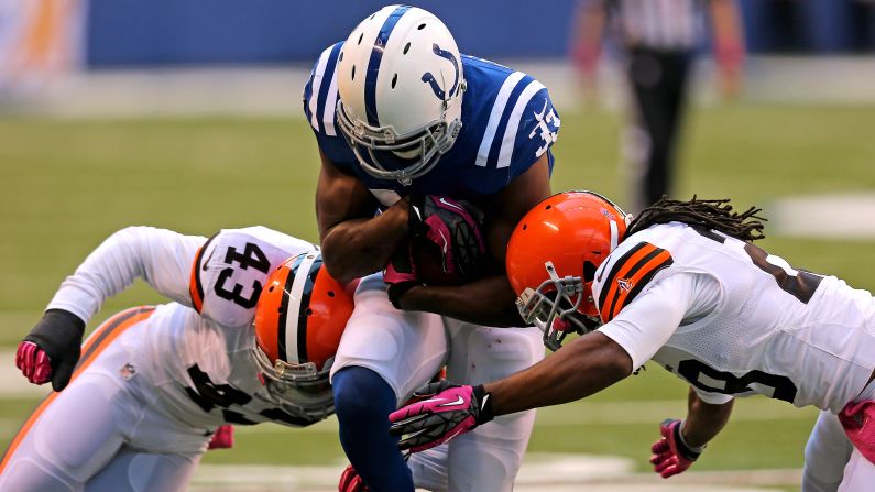 Vick Ballard of the Indianapolis Colts is hit by T.J. Ward, left, and Usama Young of the Cleveland Browns at Lucas Oil Stadium in Indianapolis on Sunday.