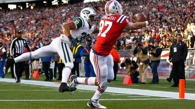 Rob Gronkowski of the New England Patriots catches a touchdown pass in front of LaRon Landry of the New York Jets.
