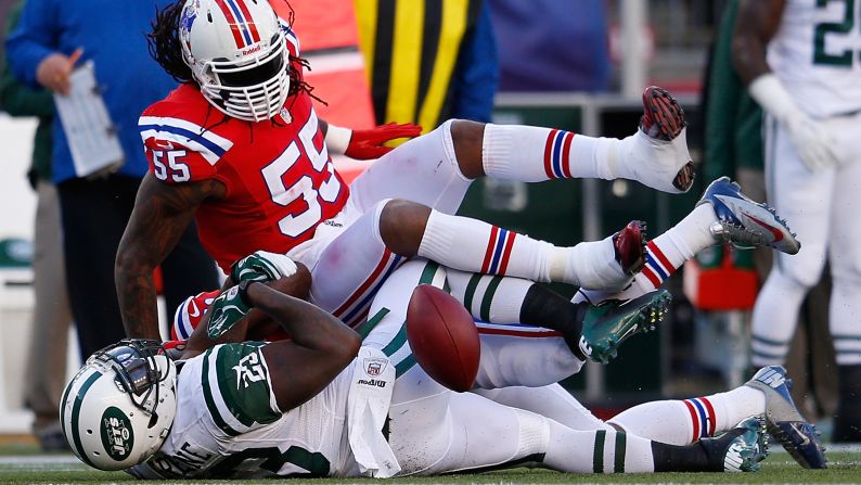 Brandon Spikes of the Patriots stops Shonn Greene of the Jets in the first half on Sunday.