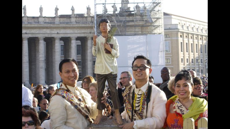 Pilgrims wait for the ceremony to begin on Sunday.