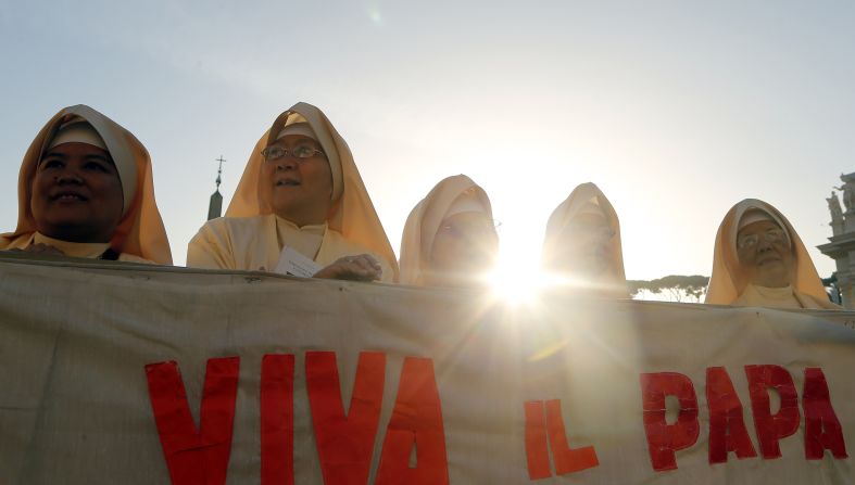 Nuns hold a banner at the ceremony on Sunday.