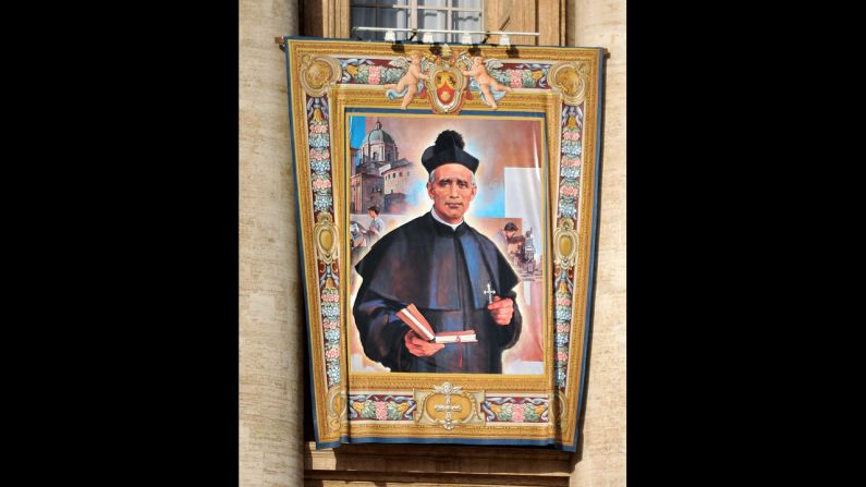 The tapestry of the new saint Giovanni Battista Piamarta hangs on St. Peter's Basilica on Sunday.