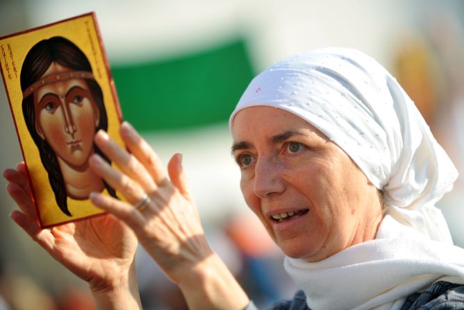 An attendee holds a painting representing Kateri Tekakwitha on Sunday.