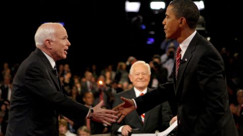 Bob Schieffer waits while John McCain and Barack Obama greet each other before their final debate in October 2008.
