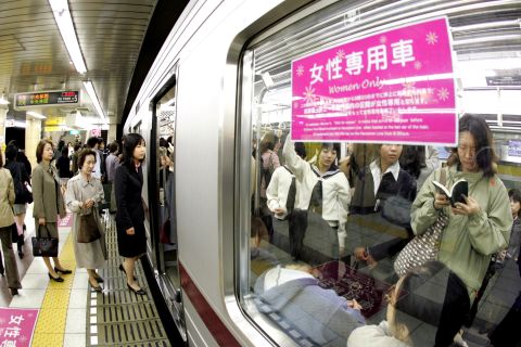 Female passengers board a "women-only" carriage at a metro station. Several private railways and subway trains operated by the Tokyo metropolitan government run the carriages during the morning rush hour in order to prevent "chikan" (groping) in crowded trains.