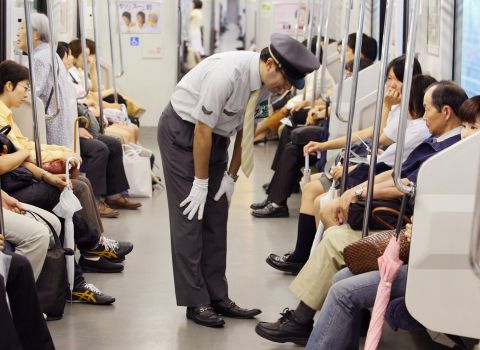 A station staff member bows his head in front of passengers to apologize for delayed train at Japan Railway's station in Saitama city, northern Tokyo. The rail and subway network runs very smoothly, says Barron. "Compared to New York, [Tokyo] is really efficient, really orderly, really clean ... "