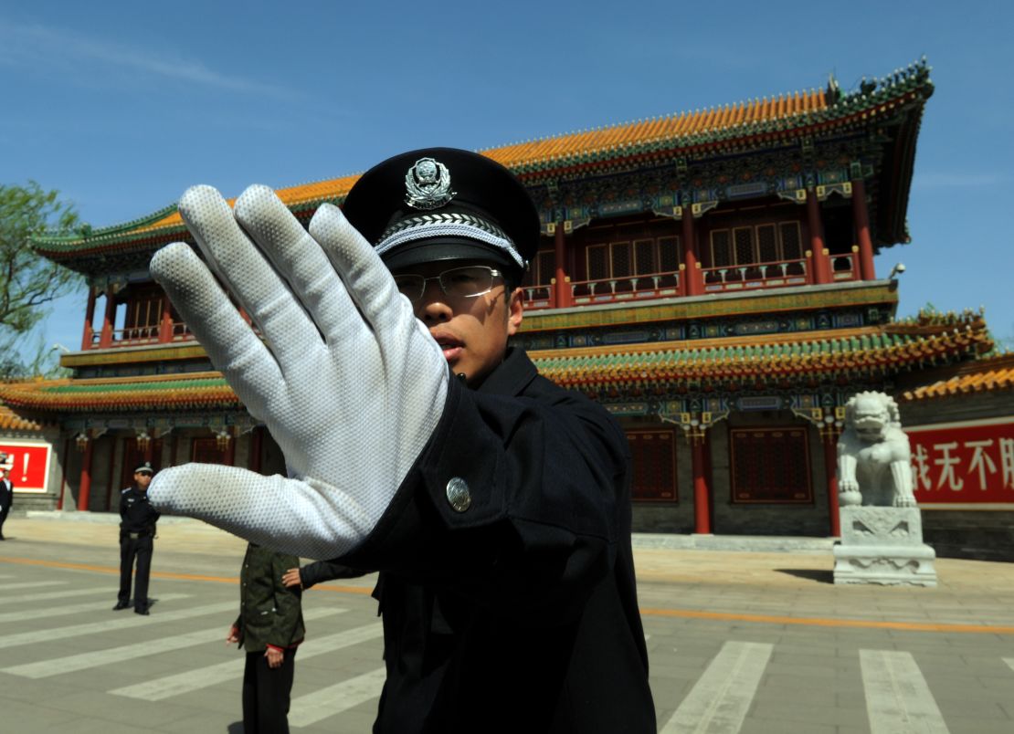 Chinese police block photos being taken outside Zhongnanhai, the Communist Party of China's central headquarters.